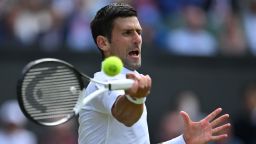 Serbia's Novak Djokovic returns the ball to Serbia's Miomir Kecmanovic during their men's singles tennis match on the fifth day of the 2022 Wimbledon Championships at The All England Tennis Club in Wimbledon, southwest London, on July 1, 2022. - RESTRICTED TO EDITORIAL USE (Photo by Glyn KIRK / AFP) / RESTRICTED TO EDITORIAL USE (Photo by GLYN KIRK/AFP via Getty Images)