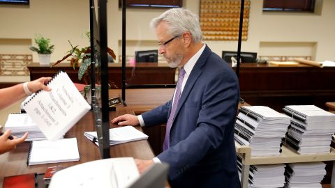 Attorney Don Knight hands over documents inside the Oklahoma Court of Criminal Appeals office in Oklahoma City, Friday, July 1, 2022, as he files for a new hearing for his client, death row inmate Richard Glossip.