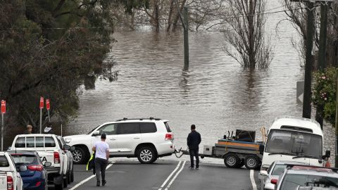 Locals rescue furniture from a home threatened by flooding in Camden, South Western Sydney, July 3, 2022.