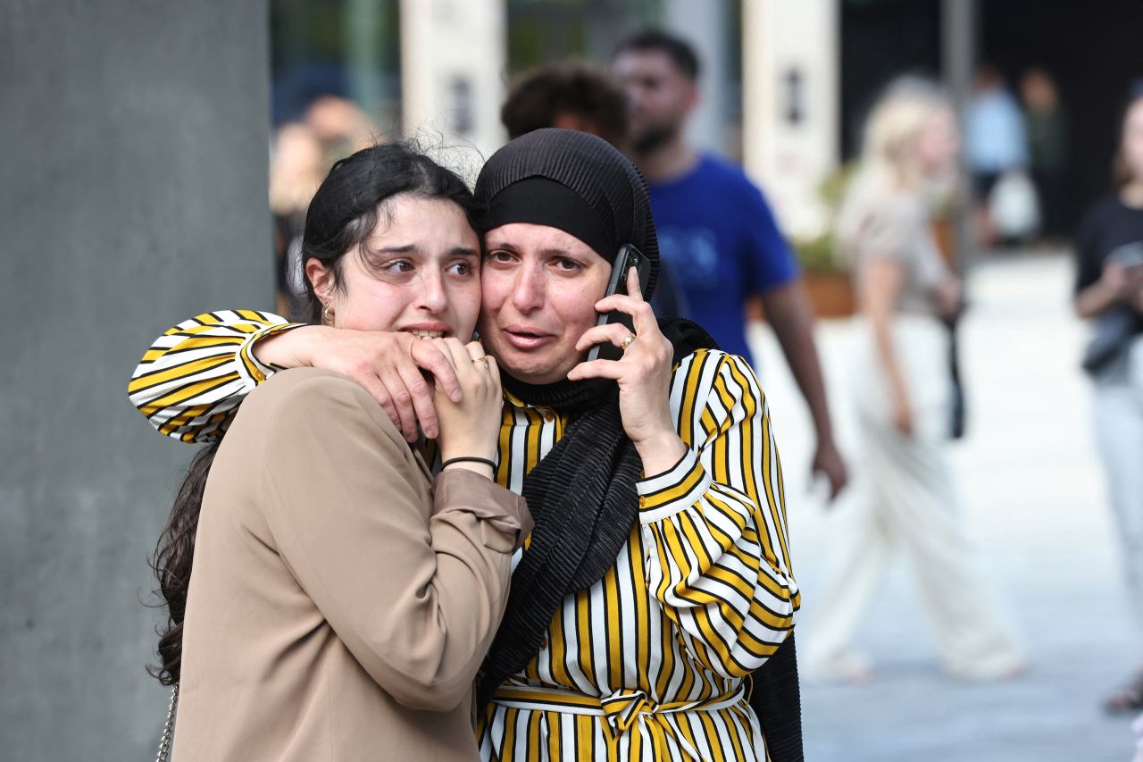 People outside the Field's shopping center in Copenhagen on July 3 react to news of the shooting.