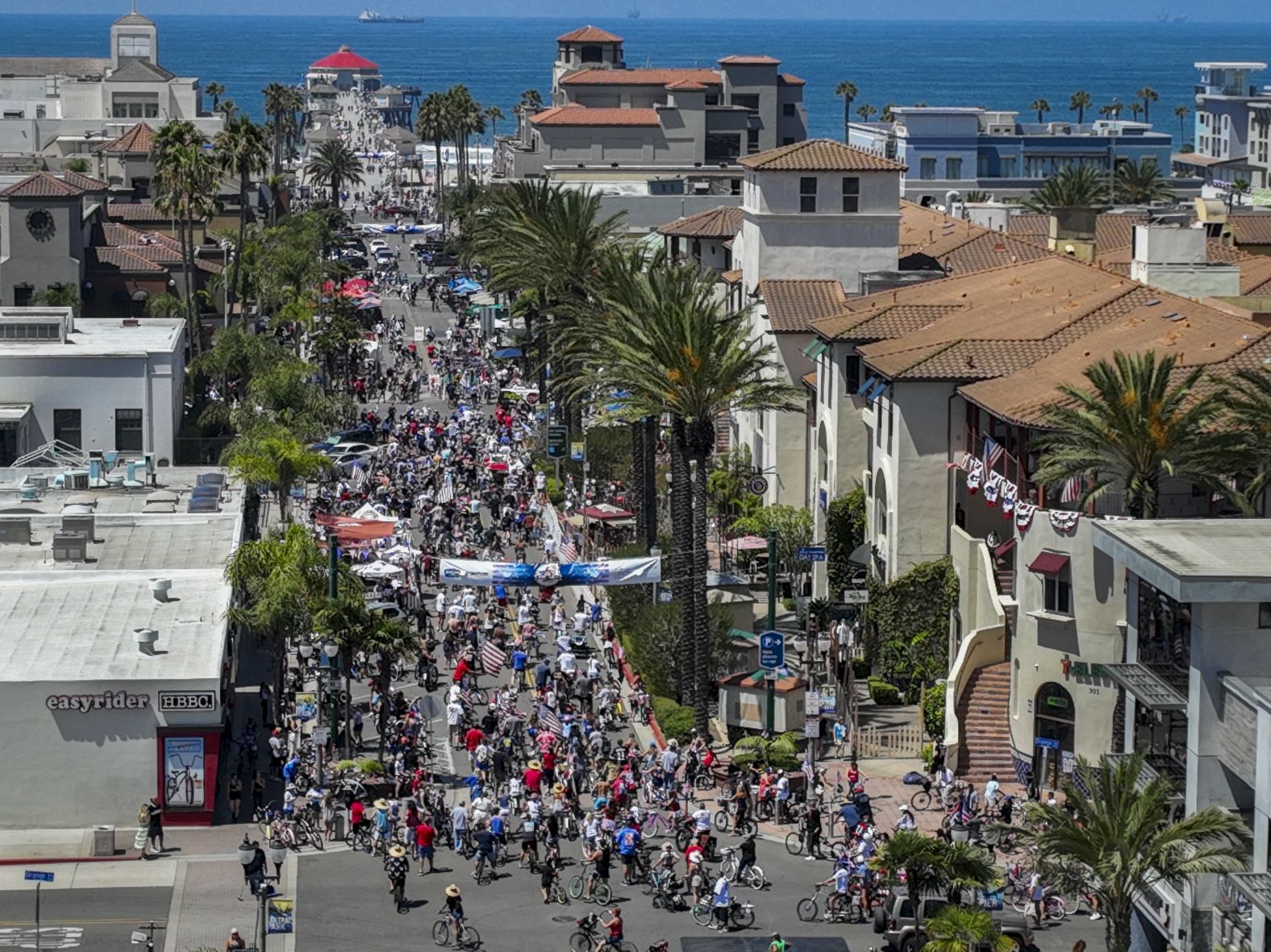 More than 1,000 people make their way down Main Street in Huntington Beach, California, for the third annual Fourth of July Bicycle Cruise on Saturday.