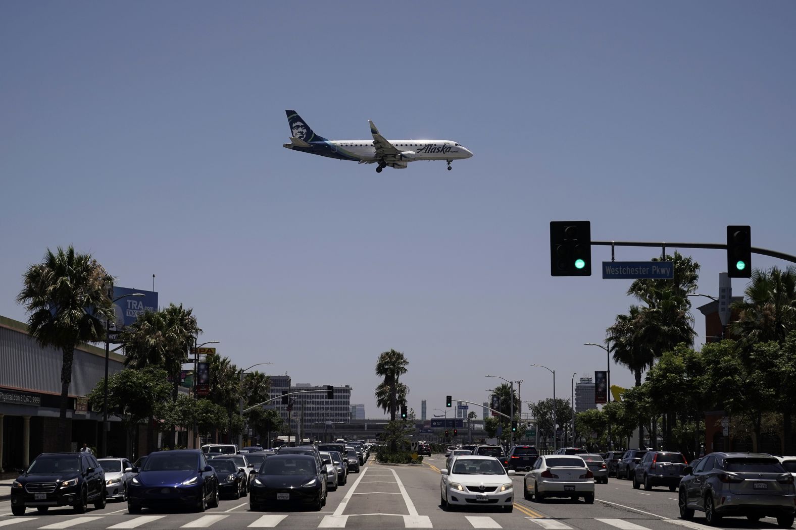 An Alaska Airlines passenger jet prepares to land at the Los Angeles International Airport on Friday. The Fourth of July holiday weekend got off to a booming start with airport crowds crushing the numbers seen in 2019.