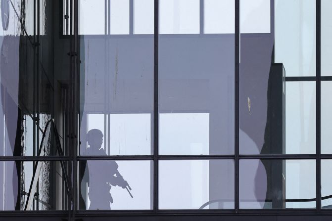 An armed police officer responds to reports of a shooting at the Field's shopping center in Copenhagen, Denmark, on July 3. Danish police said several people were killed in the shooting.