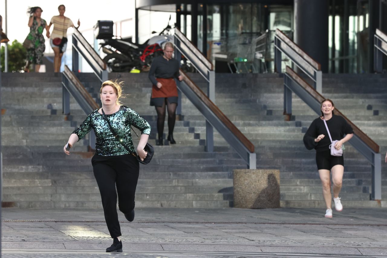 People flee the Field's shopping center in Copenhagen, Denmark, after a shooting on July 3. Several people were killed and several wounded in the shooting, Danish police said.