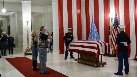 People salute the casket of Hershel "Woody" Williams set up in the first floor rotunda of the West Virginia State Capitol in Charleston, West Virginia, for visitation on Saturday, July 2, 2022. 