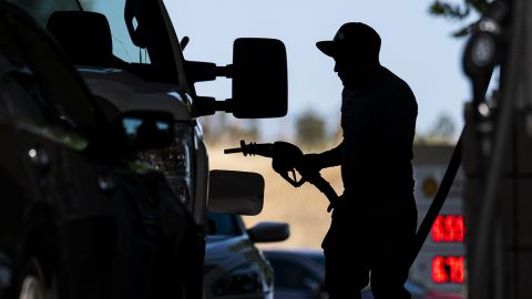 A customer holds a fuel cap at a Shell gas station in Hercules, California, US, on Wednesday, June 22, 2022. 