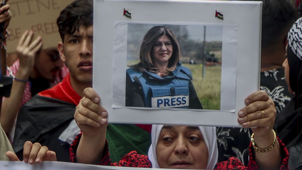 A woman holds a photograph of Palestinian-American journalist Shireen Abu Akleh during a rally in the Plaza de las Provincias, on May 15, 2022, in Madrid, Spain.