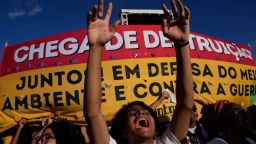 Activists shout "Bolsonaro out" during a demonstration by the "Act for the Earth" movement outside the National Congress in Brasilia, Brazil, Wednesday, March 9, 2022. Hundreds of civil society organizations joined some of Brazil's most famous musicians in an attempt to prevent the passage of the so-called "poison bill" that would loosen restrictions on the use of pesticides, plus demand effective action to contain deforestation in the Amazon and mining on Indigenous lands.
