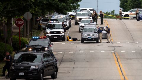 Officers work the scene after a mass shooting at a Fourth of July parade in Highland Park, Illinois.
