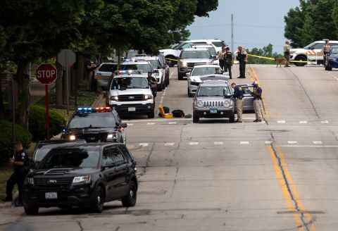 Officers on the scene after a shooting in Highland Park, Illinois. Reports indicate at least six people were killed and more than two dozen injured.