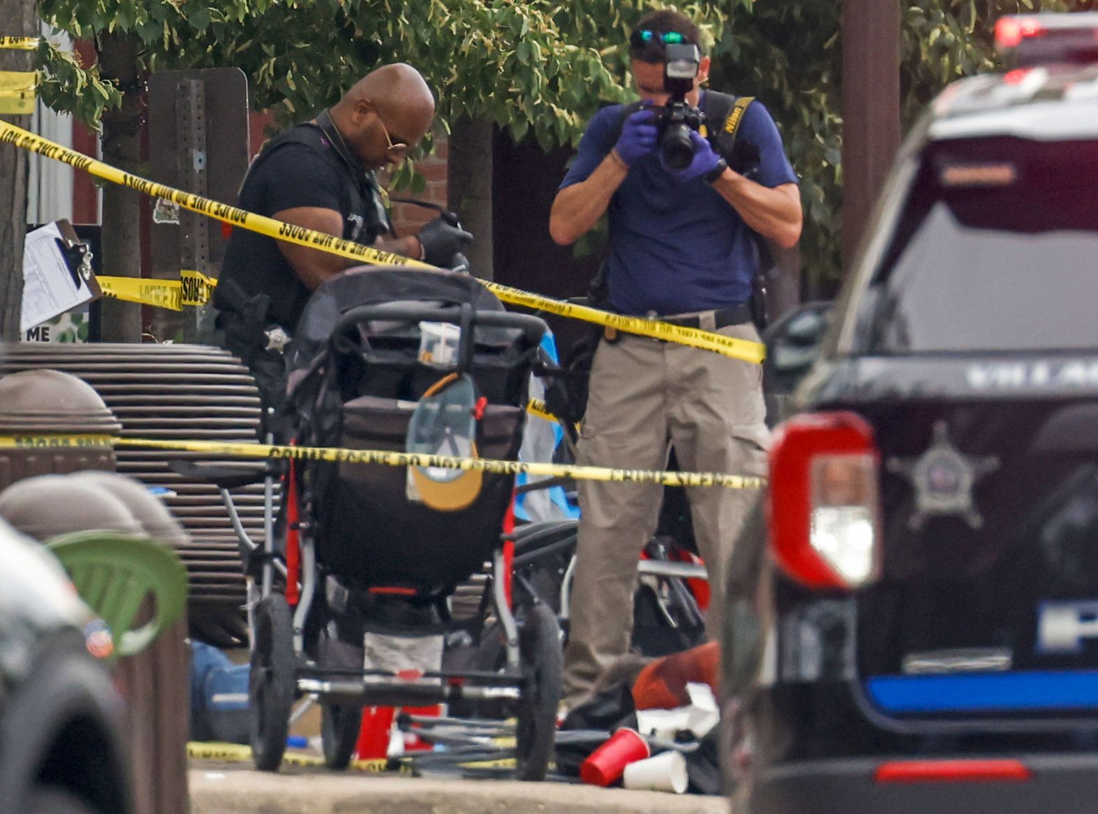 Law enforcement officers investigate the scene of the shooting.
