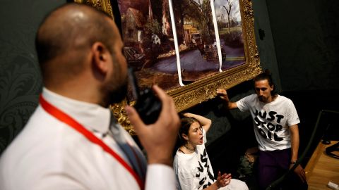 Just Stop Oil activists sticking their hands to John Constable's tire 