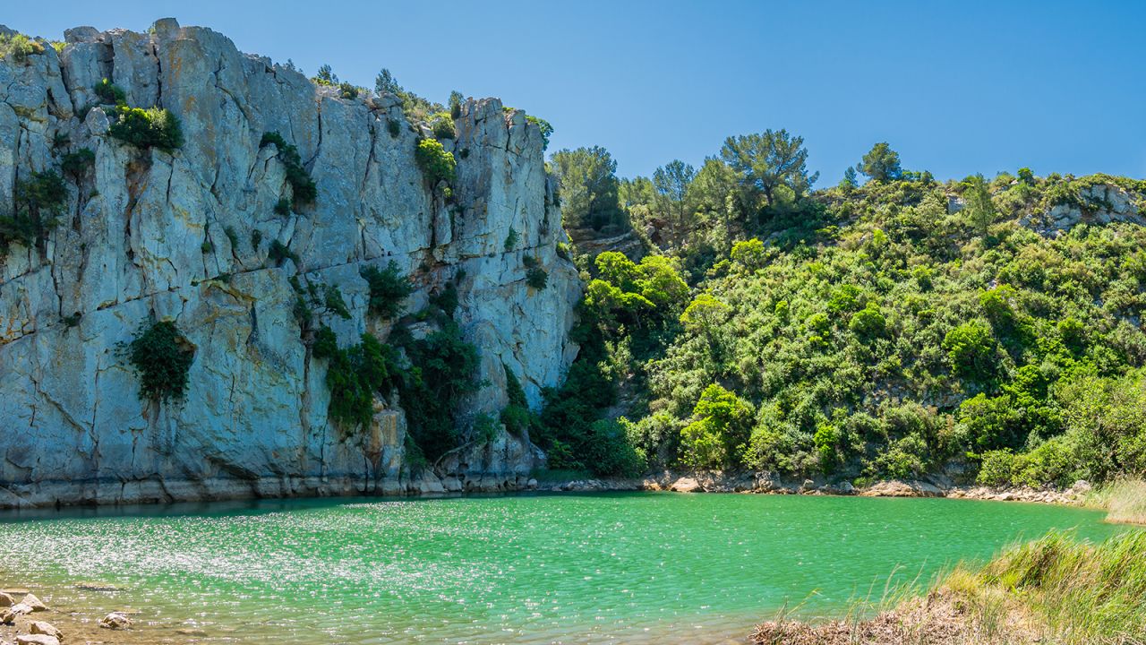 <strong>Exploring the terrain: </strong>Hiking in the countryside may reveal an unexpected view of the emerald-colored Gouffre de l'Oeil Doux ("Sweet-eyed sinkhole"). It looks inviting but swimming is prohibited.