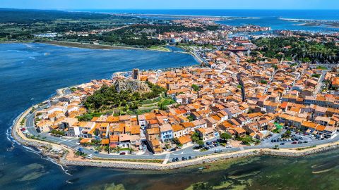 Historical circular Gruissan town built around the medieval castle with Tour Barberousse tower on Mediterranean sea coast, Aude department, southern France