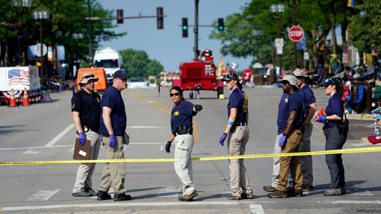 Members of the FBI's evidence response team organize one day after a mass shooting in downtown Highland Park, Illinois, on Tuesday, July 5, 2022. 