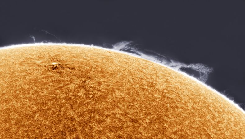 In this image, taken by Simon Tang in Los Angeles, clouds of hydrogen gas collapse as the sun's magnetic field lines fracture and collide, producing features known as prominences. 