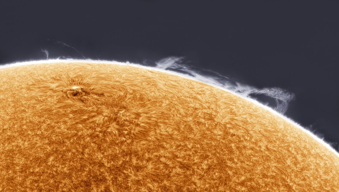 In this image, taken by Simon Tang in Los Angeles, clouds of hydrogen gas collapse as the sun's magnetic field lines fracture and collide, producing features known as prominences. 