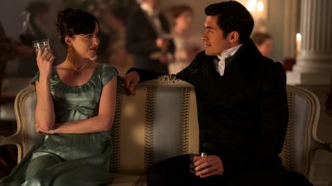 (From left) Dakota Johnson as Anne Elliot and Henry Golding as Mr. Elliot are shown in a scene from "Persuasion."