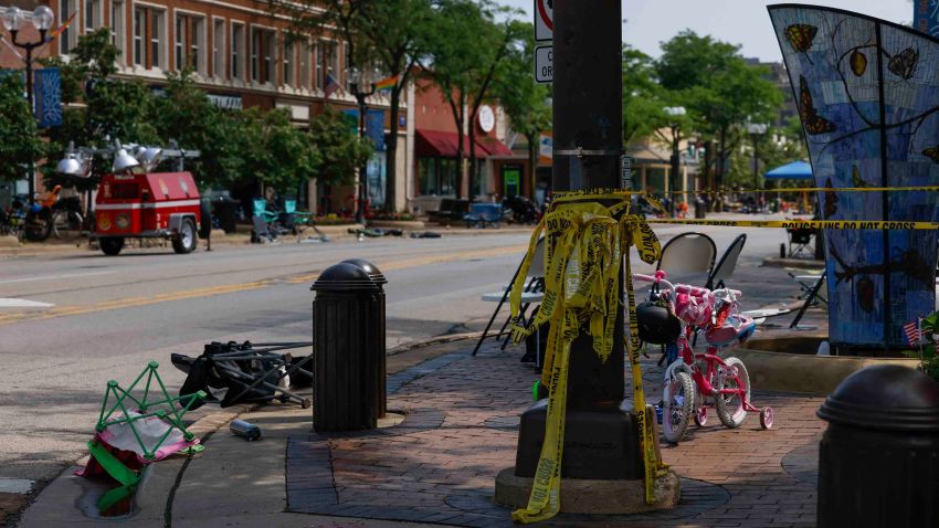 Highland Park, Ill. - July 05:  An abandoned bike and chairs at the intersection of Green Bay Road and Central Avenue on Tuesday, July 5, 2022 in Highland Park, Ill.. On July 4, a gunman fired into the crowd during a parade, leaving at least six dead and dozens wounded. Suspected shooter Robert E. Crimo III is in police custody. (Taylor Glascock/CNN Digital)