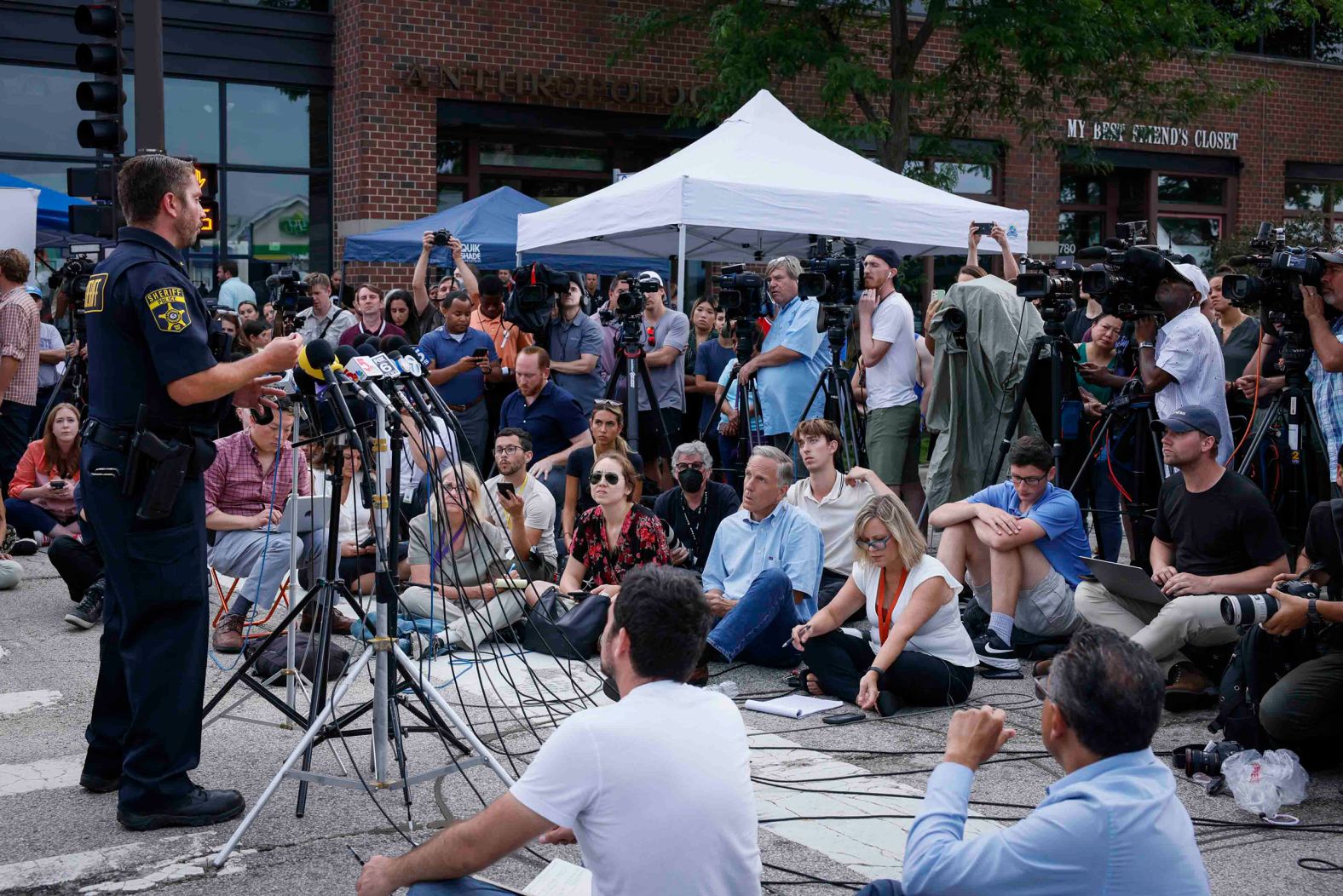 Journalists and residents listen during a press conference on July 5. 