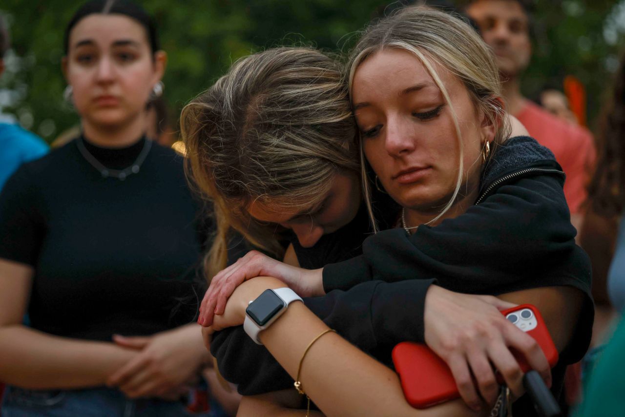 Ellie Zuckerman, left, 18, holds her friend Ava Turner , 17, during a vigil for the victims on July 5.