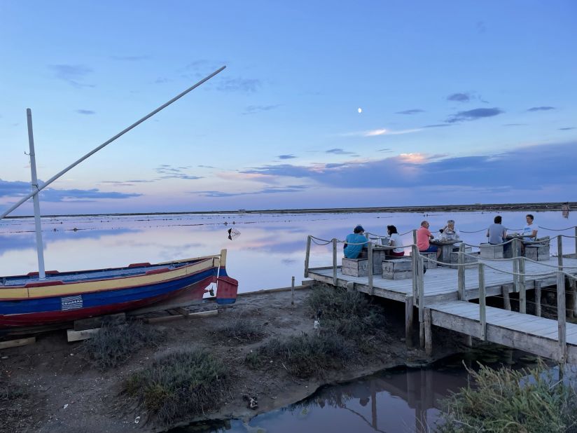 <strong>Al fresco dining:</strong> La Cambuse du Saunier near Gruissan dishes up fresh seafood at rustic driftwood tables next to a salt lagoon.