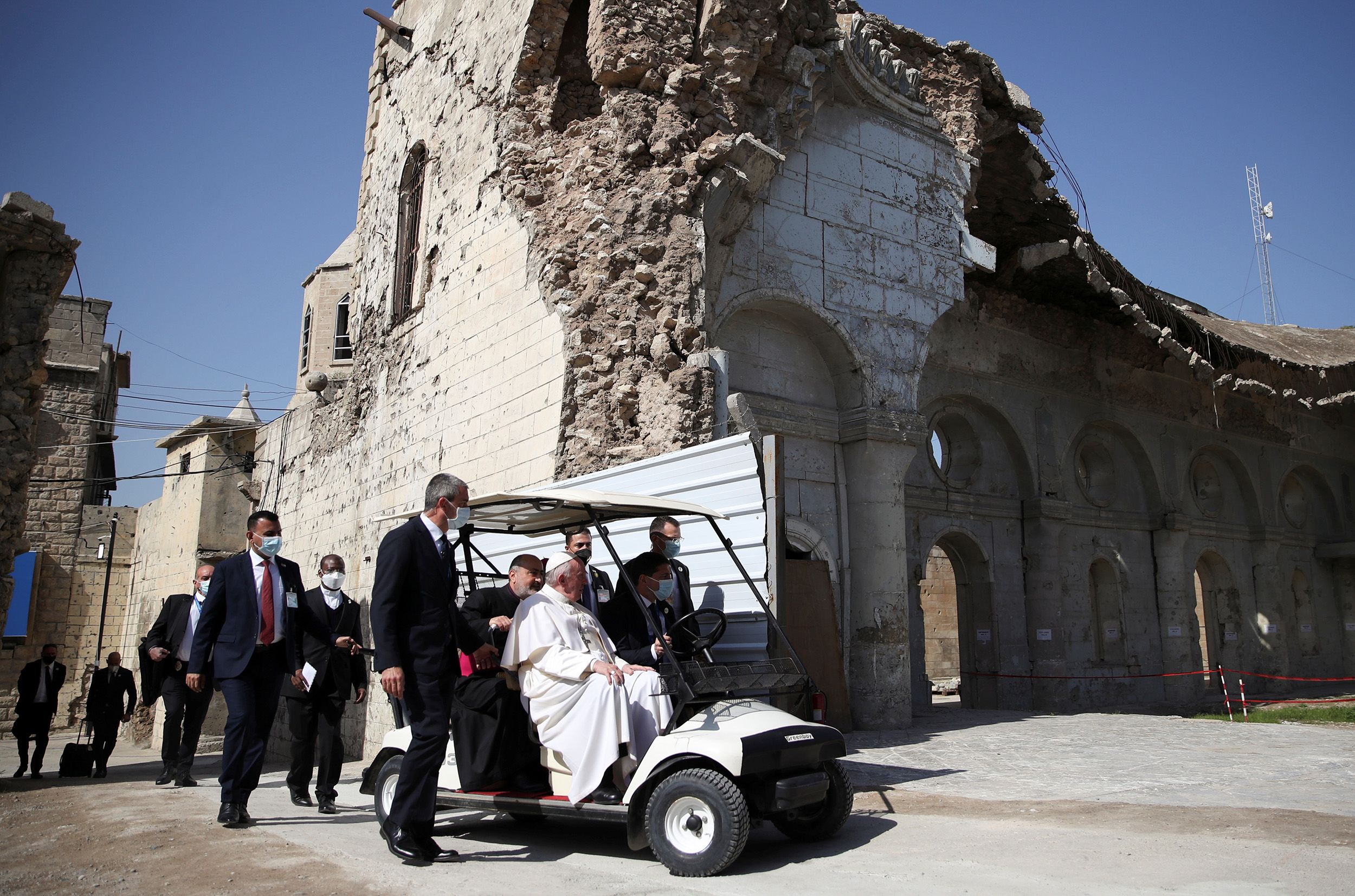 Francis, surrounded by the remains of destroyed churches, is driven in Mosul, Iraq, in March 2021.