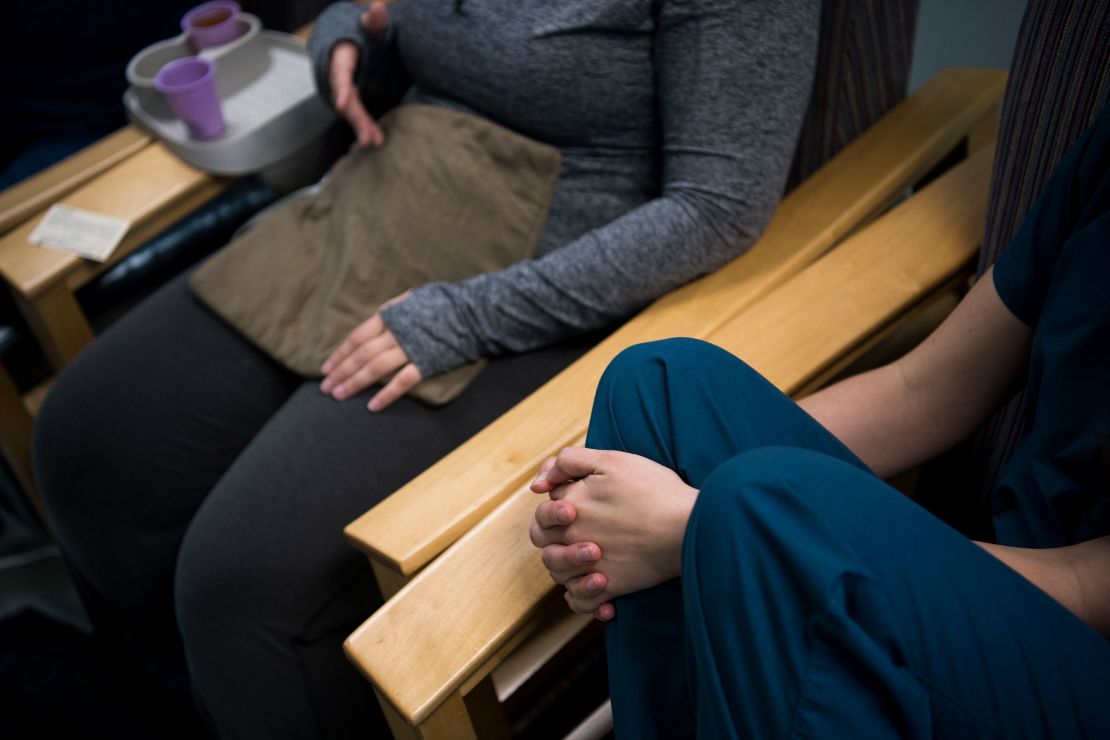 An abortion doula speaks with a patient after the procedure at Falls Church Healthcare Center in Virginia on November 24, 2017. 