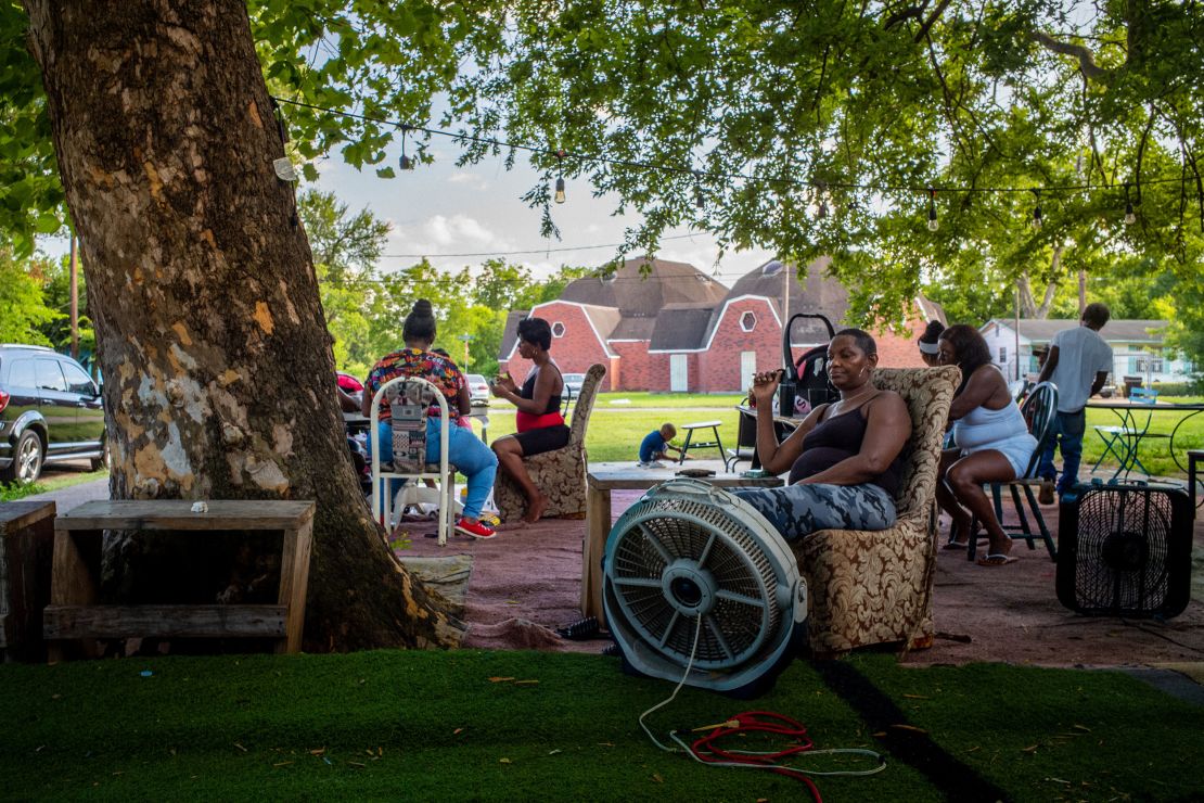 The Johnson family cools off outside their Houston home during a particularly intense early season heat wave in June. 