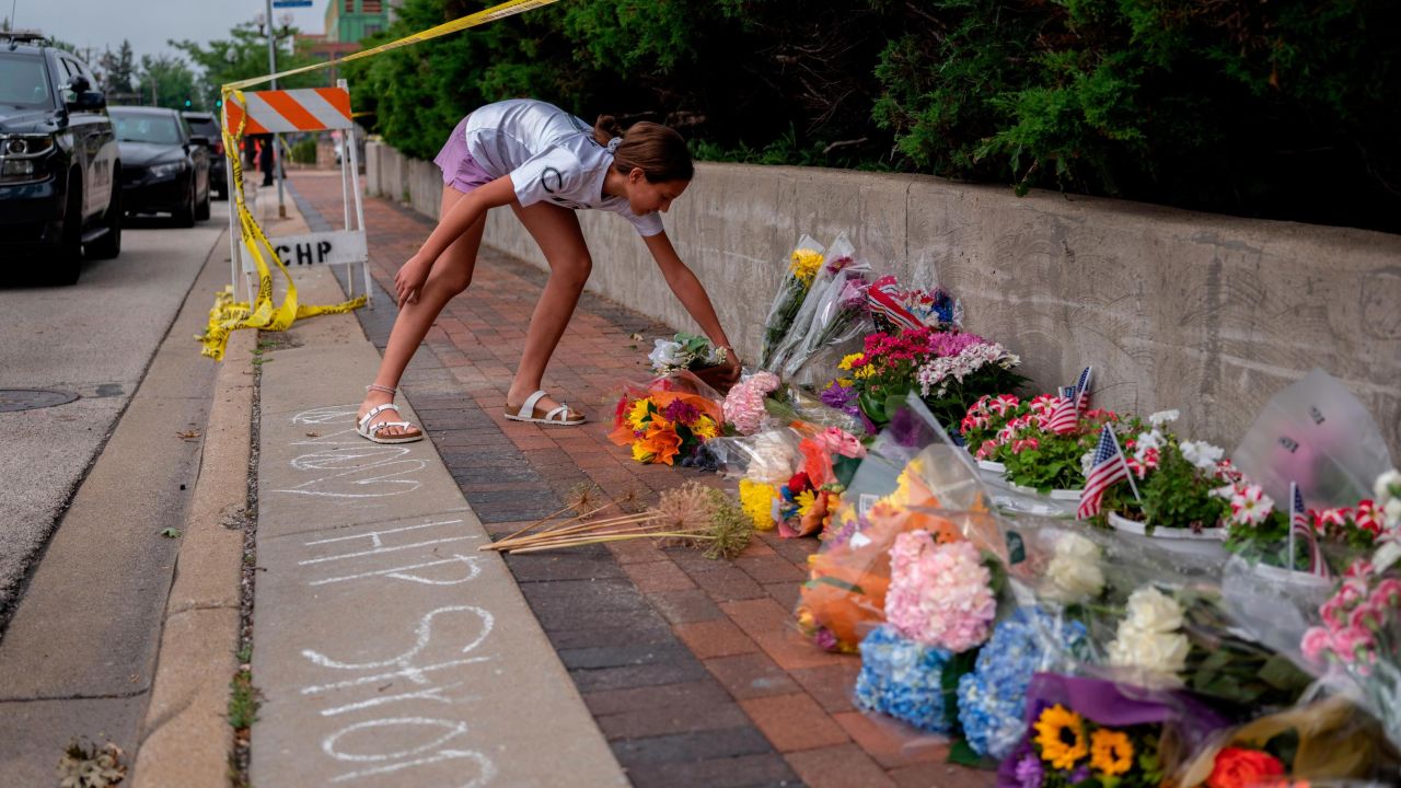 A mourner visits a memorial for the victims of a mass shooting in Highland Park.