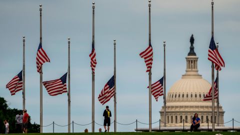 American flags surrounding the Washington Monument fly at half-staff in May 2022 after the deadly shooting at an elementary school in Uvalde, Texas.