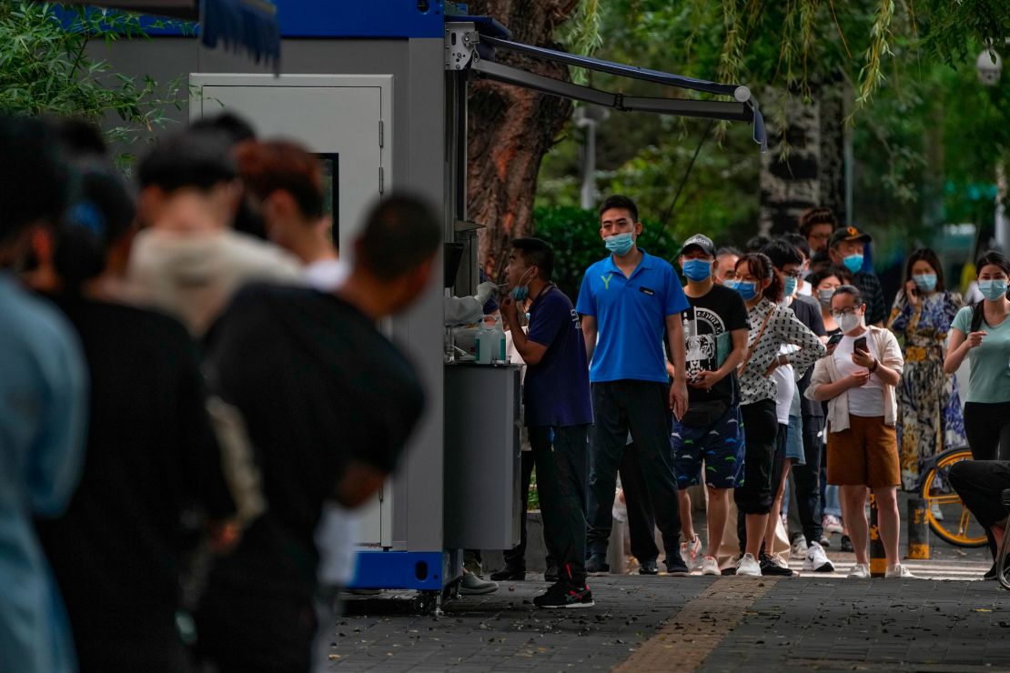 People stand in line at a coronavirus testing site in Beijing on July 4.