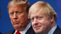 TOPSHOT - Britain's Prime Minister Boris Johnson (R) welcomes US President Donald Trump (L) to the NATO summit at the Grove hotel in Watford, northeast of London on December 4, 2019. (Photo by PETER NICHOLLS / various sources / AFP) (Photo by PETER NICHOLLS/AFP via Getty Images)