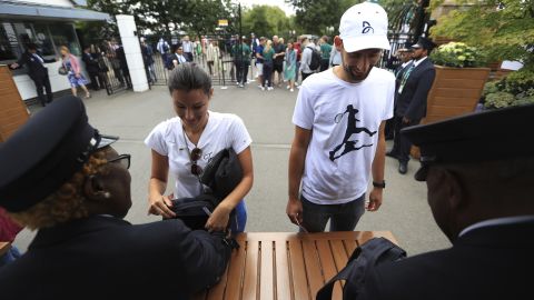 Spectators go through security checks at the entrance gate at Wimbledon.