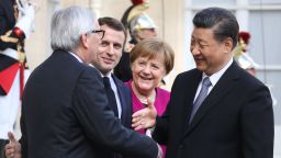 TOPSHOT - French President Emmanuel Macron (2ndL) welcomes EU Commission President Jean-Claude Juncker (L),  German Chancellor Angela Merkel (C) and Chinese President Xi Jinping (R) before a meeting at the Elysee Palace in Paris on March 26, 2019. - The leaders of China, France, Germany and the EU were set to meet in Paris on March 26 for "unprecedented" talks on how to improve ties, despite growing jitters over Beijing's massive investments in Europe. (Photo by ludovic MARIN / AFP)        (Photo credit should read LUDOVIC MARIN/AFP via Getty Images)