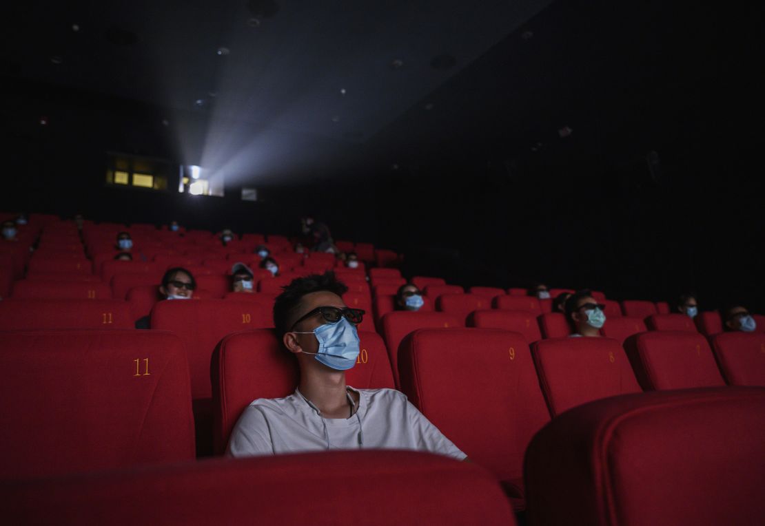 People wearing protective masks as they watch a movie in 3D at a theater on the first day they were permitted to open in Beijing on July 24, 2020. China's box office became the world's largest that year, according to Comscore data.