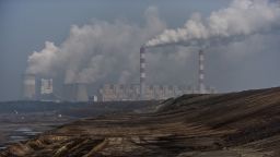 Steam and smoke rises from the Belchatow Power Station, pictured from a viewing point over the open-pit coal mine on February 23, 2021 in Rogowiec, Poland. 