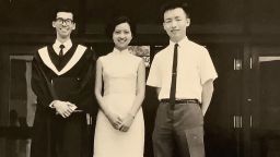 Ing-Ning "John" Han, right, stands with classmates on graduation day in 1970 from National Chengchi University in Taiwan. 