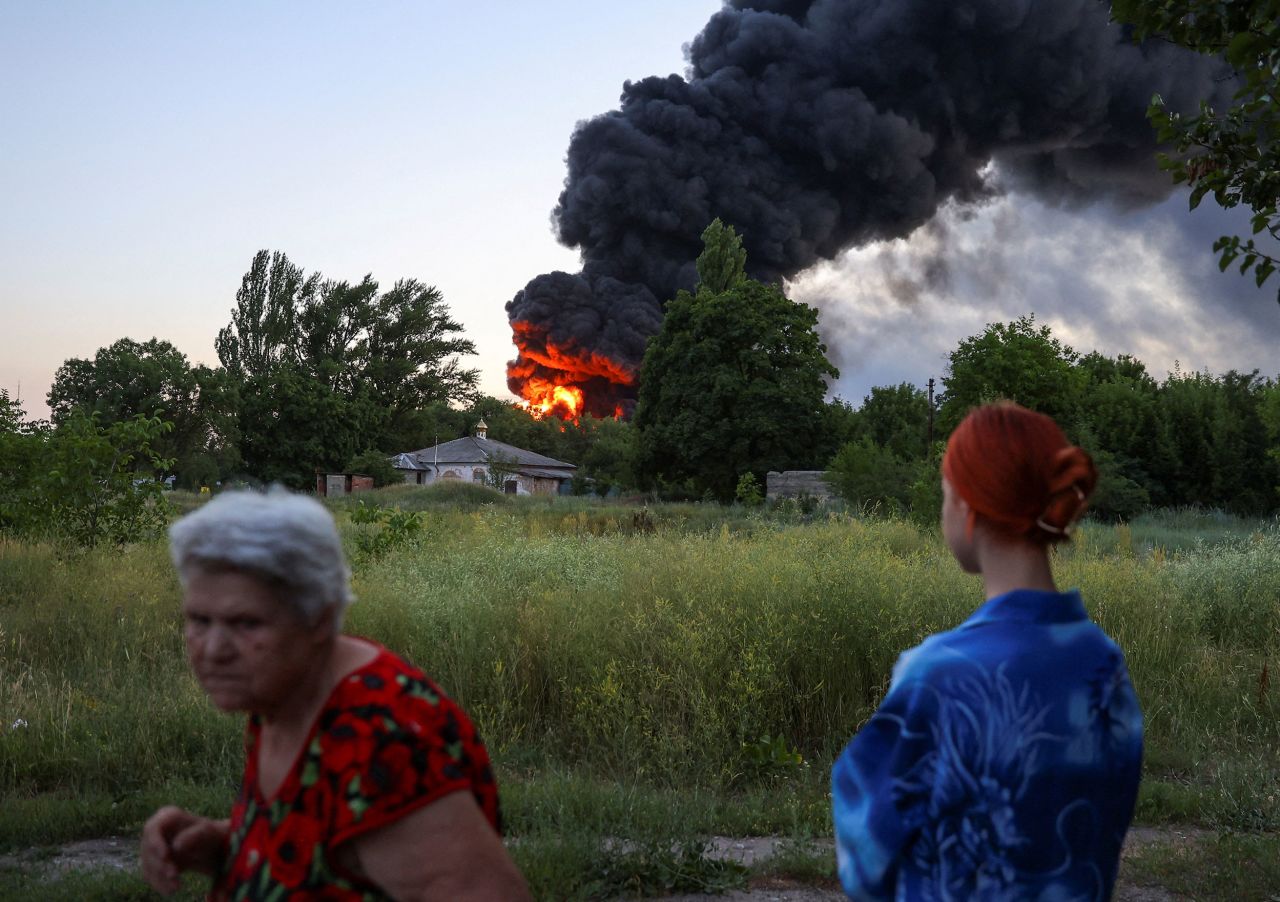 A local resident watches smoke rise after shelling in Donetsk, Ukraine, on Thursday, July 7. Russia and Ukraine continue to battle in <a href="https://www.cnn.com/2022/04/15/europe/donbas-region-ukraine-war-russia-explainer-intl/index.html" target="_blank">the country's eastern region of Donbas.</a>