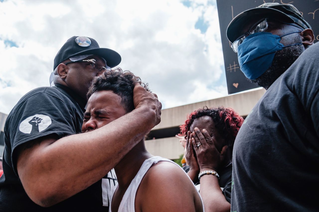 Javon Williams, 13, is comforted by the Rev. Jaland Finney as he speaks during a march and rally for Jayland Walker in Akron, Ohio, on Sunday, July 3. Javon had just viewed the video released by police detailing Walker's shooting death. <a href="https://www.cnn.com/2022/07/04/us/jayland-walker-shooting-what-we-know/index.html" target="_blank">Walker was shot by police</a> after fleeing an attempted traffic stop last month.