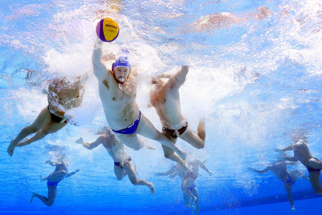 Greek water polo player Konstantinos Kakaris swims away from Italian defenders during a match at the World Championships on Friday, July 1.