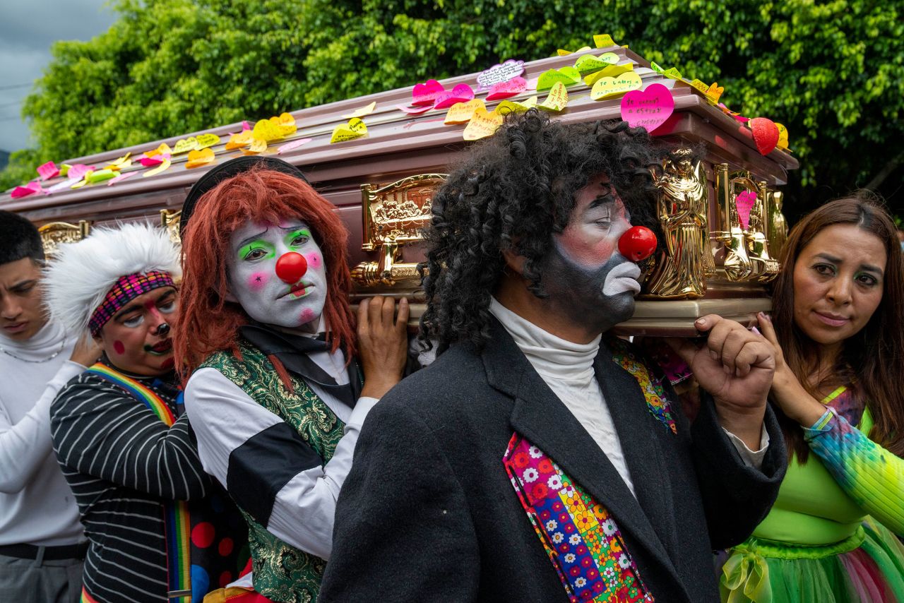 Clowns carry the coffin of Joselin Chacón Lobo, a clown known as "Chispita," at a cemetery in Amatitlán, Guatemala, on Sunday, July 3. Chacón Lobo and her partner, Nelson Estiven Villatoro, were missing for almost two months when their bodies were found buried in a clandestine site in a peripheral area of the Guatemalan capital.