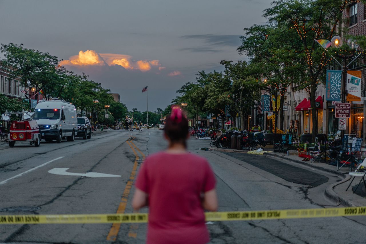 A woman stands in Highland Park, Illinois, after a <a href="http://www.cnn.com/2022/07/04/us/gallery/4th-of-july-shooting-in-highland-park-illinois/index.html" target="_blank">mass shooting</a> took place during the city's Fourth of July parade on Monday.