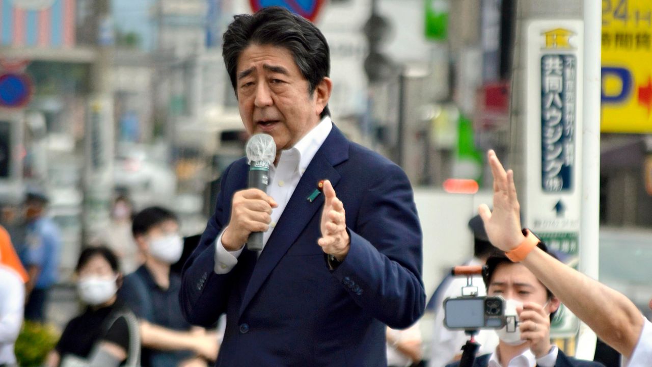 Japanese former Shinzo Abe speaks for his party member candidate of the House of Councillors Election near Yamato Saidaiji Station in Nara Prefecture on July 8, 2022, just seconds before he is shot.   67-year-old Abe has reportedly been shot in the chest and he has been in a state of cardio-respiratory arrest. ( The Yomiuri Shimbun via AP Images )
