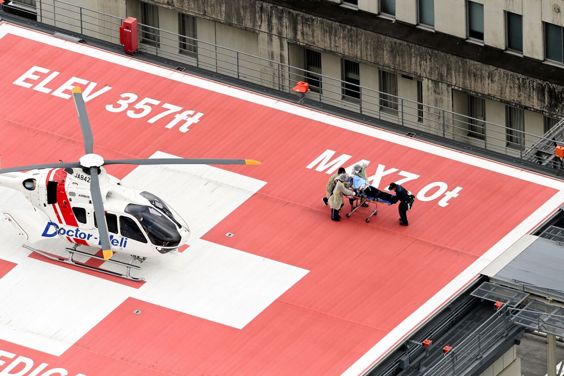 In this aerial image, former Prime Minister Shinzo Abe is on a stretcher to a helicopter after being shot in front of Yamatosaidaiji Station on July 8.