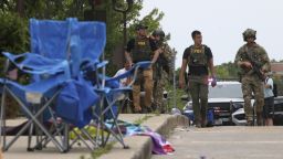 Law enforcement officers from multiple jurisdictions investigate the area in Highland Park, Illinois, on Monday, July 4, 2022, after a shooter fired on the Chicago suburb's Fourth of July parade.