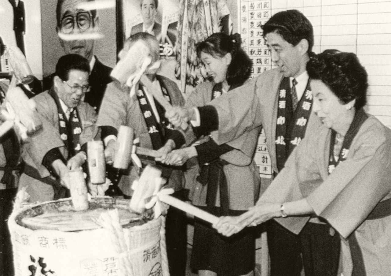 Abe breaks the lid of a sake barrel to celebrate winning a seat in the Japanese House of Representatives in 1993. Abe's father, Shintaro, once held the same position.