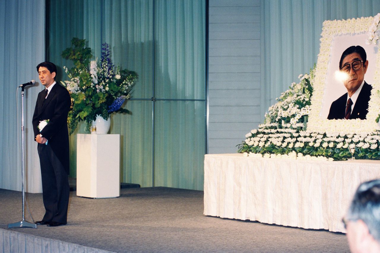 Abe addresses his father's memorial ceremony in Tokyo in 1993.