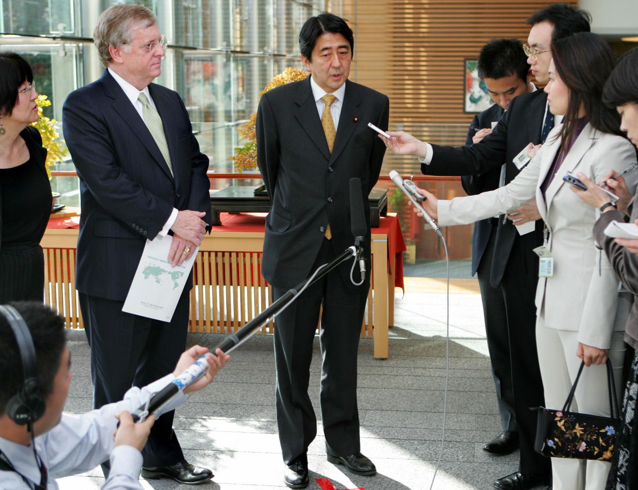 Abe speaks to reporters after having lunch with Thomas Schieffer, the US Ambassador to Japan, in 2005. Abe at the time was Japan's chief cabinet secretary.