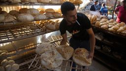 A worker arranges freshly baked bread for sale at the Al-Monira market in Cairo, Egypt, on Wednesday, June 1, 2022. 
